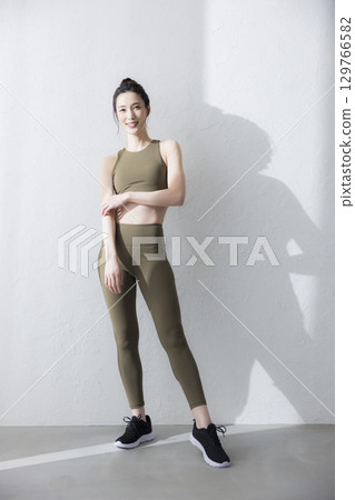 A woman stretching in training wear A woman stretching in training wear 129766582