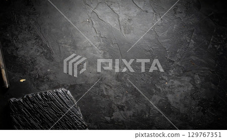 A textured surface of a dark grunge metal wall with an old concrete pattern A textured surface of a dark grunge metal wall with an old concrete pattern 129767351
