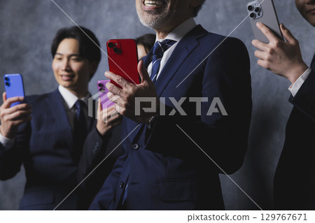 Businessmen with smartphones Businessmen with smartphones 129767671