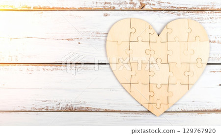 A vintage paper card with a textured heart shape on an old wooden background, perfect for a Valentine's Day design A vintage paper card with a textured heart shape on an old wooden background, perfect for a Valentine's Day design 129767920