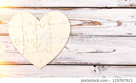 A vintage paper card with a textured heart shape on an old wooden background, perfect for a Valentine's Day design A vintage paper card with a textured heart shape on an old wooden background, perfect for a Valentine's Day design 129767921