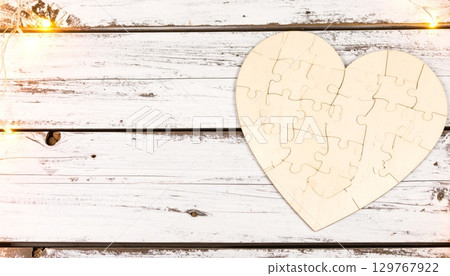 A vintage paper card with a textured heart shape on an old wooden background, perfect for a Valentine's Day design A vintage paper card with a textured heart shape on an old wooden background, perfect for a Valentine's Day design 129767922