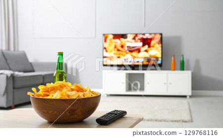 Luxurious living room interior with a fireplace, flat-screen television, and comfortable furniture Luxurious living room interior with a fireplace, flat-screen television, and comfortable furniture 129768116