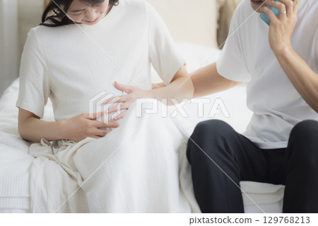 Pregnant couple in the bedroom Pregnant couple in the bedroom 129768213