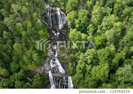 Amazing summer landscape with forest river waters falling down in big waterfall with clear water between rocky boulders in Nantahala National Forest. Whitewater Falls, North Carolina, USA 129769254