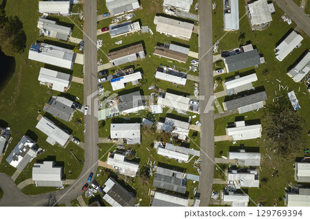 Destroyed by hurricane Ian suburban houses in Florida mobile home residential area. Consequences of natural disaster 129769394