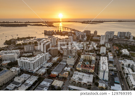 Aerial view of Sarasota city downtown at sunset with high-rise office buildings and Ringling Bridge on horizon. Real estate development in Florida. USA travel destination Aerial view of Sarasota city downtown at sunset with high-rise office buildings and Ringling Bridge on horizon. Real estate development in Florida. USA travel destination 129769395