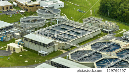 Aerial view of modern water cleaning facility at urban wastewater treatment plant. Purification process of removing undesirable chemicals, suspended solids and gases from contaminated liquid 129769397