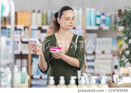 Woman are busy choosing paracetamol tablet box at pharmacy Woman are busy choosing paracetamol tablet box at pharmacy 129769506