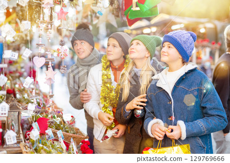 Family of four choosing decorations at Christmas fair Family of four choosing decorations at Christmas fair 129769666