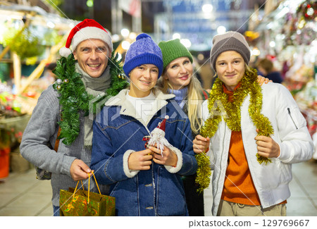 Portrait of family visiting Christmas street fair Portrait of family visiting Christmas street fair 129769667