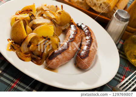 Roasted sausages with potatoes Roasted sausages with potatoes 129769807