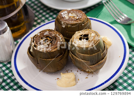 Delicious steamed artichoke 129769894