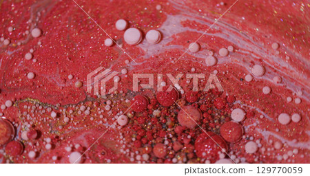 Oil fluid. Paint art. Blur red pink white color flowing wet stains golden droplets liquid shimmering particles spreading on abstract acrylic background. Oil fluid. Paint art. Blur red pink white color flowing wet stains golden droplets liquid shimmering particles spreading on abstract acrylic background. 129770059