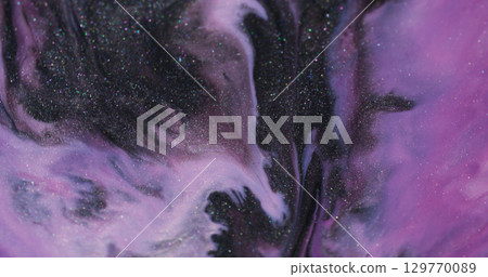 Shiny ink. Acrylic fluid. Defocused purple pink blue color pigment dark black wet glitter stains floating on abstract art background. Shiny ink. Acrylic fluid. Defocused purple pink blue color pigment dark black wet glitter stains floating on abstract art background. 129770089