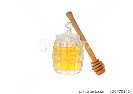 A jar of honey with a wooden dipper, isolated on white, PNG 129770560