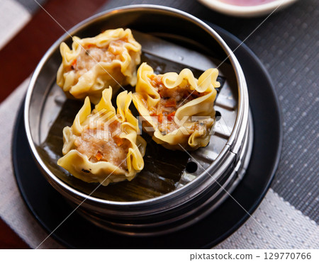Chinese dish - dumplings shumai with soy sauce 129770766