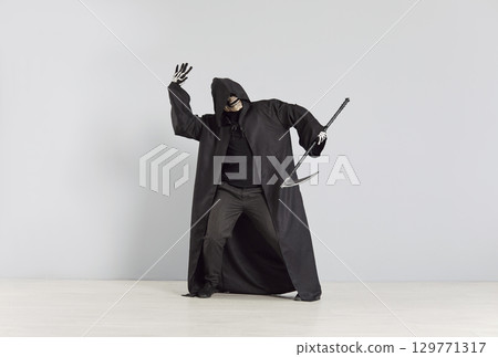 Grim Reaper Dancing With Scythe At Halloween Party On Grey Background Grim Reaper Dancing With Scythe At Halloween Party On Grey Background 129771317