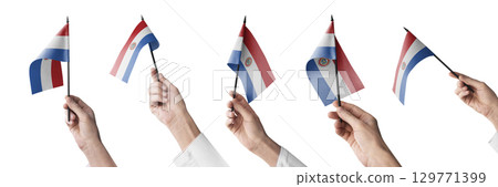 The Paraguay flag in hand in different angles on a white background 129771399