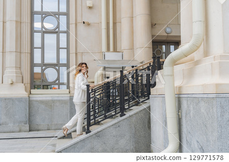 Woman White Suit Stairs Building Entrance Woman White Suit Stairs Building Entrance 129771578