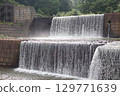 An artificial, long waterfall that regulates the flow of a river 129771639