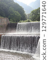 An artificial, long waterfall that regulates the flow of a river 129771640