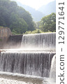 An artificial, long waterfall that regulates the flow of a river 129771641
