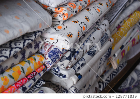 heap of colorful cloth on shelf for sale in store 129771839