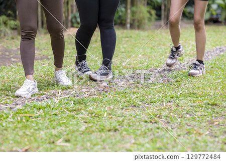 People in a sporty outfit walking together in a public park outdoors. Concept of a Healthy active lifestyle People in a sporty outfit walking together in a public park outdoors. Concept of a Healthy active lifestyle 129772484