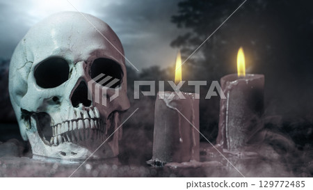 Human head skull with fire candles for ritual at a scary night scene background. Concept of Spooky Halloween 129772485