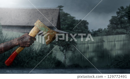 Zombie hands with a bloody wound holding an axe with a night scene background. Zombie, devil, evil, satan, or monster hands. The scene is dark and scary. Concept of Spooky Halloween 129772491