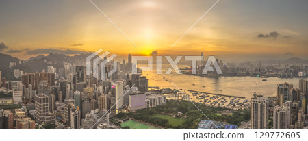 Aug 8 2025 Victoria Harbour glowing under vibrant sunset sky 129772605