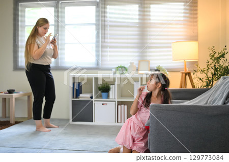 Mom and child spending time at home together Mom and child spending time at home together 129773084