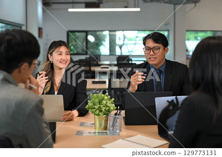 Group of professionals discussing ideas during a corporate meeting 129773131