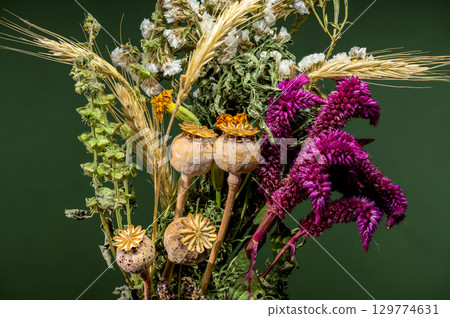 Dried Floral Arrangement with Wheat and Poppy Pods on Green 129774631