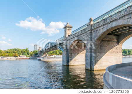 View of the Moscow river embankment, Pushkinsky bridge and cruise ships at sunset. 129775206