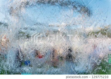 Aqua background. Product space next to clean water streams and water splashes and drops. 129775210