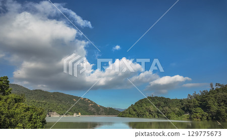 Peaceful Lake Scene Surrounded by Lush Green Hills Peaceful Lake Scene Surrounded by Lush Green Hills 129775673
