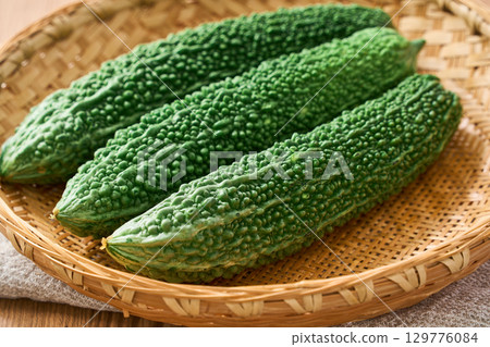 Bitter melon | Okinawan summer vegetables served on a bamboo basket Bitter melon | Okinawan summer vegetables served on a bamboo basket 129776084