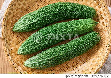 Bitter melon | Okinawan summer vegetables served on a bamboo basket Bitter melon | Okinawan summer vegetables served on a bamboo basket 129776087