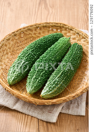 Bitter melon | Okinawan summer vegetables served on a bamboo basket 129776092