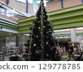 A huge Christmas tree decorated in a shopping mall 129778785