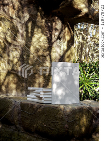 Book mockup on natural stone background outdoors, blank cover for design, branding, education, storytelling, creativity, and inspirational concepts Book mockup on natural stone background outdoors, blank cover for design, branding, education, storytelling, creativity, and inspirational concepts 129779723