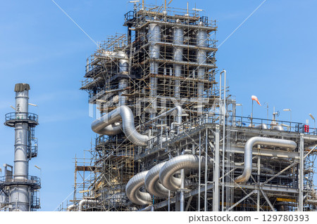 Oil and Gas refinery petrochemical plant industrial on blue sky background, Oil and Gas refinery petrochemical plant pipeline steel, Oil and Gas refinery factory maintenance, Global energy refinery. 129780393