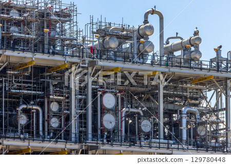 Oil and Gas refinery petrochemical plant industrial on blue sky background, Oil and Gas refinery petrochemical plant pipeline steel, Oil and Gas refinery factory maintenance, Global energy refinery. 129780448