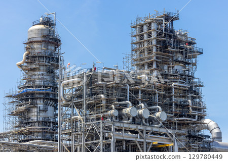 Oil and Gas refinery petrochemical plant industrial on blue sky background, Oil and Gas refinery petrochemical plant pipeline steel, Oil and Gas refinery factory maintenance, Global energy refinery. 129780449