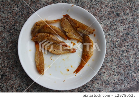 dried fish in basket and plate dried fish in basket and plate 129780523