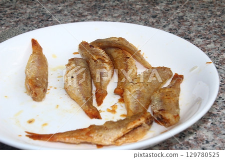 dried fish in basket and plate dried fish in basket and plate 129780525
