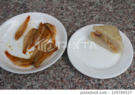 dried fish in basket and plate 129780527