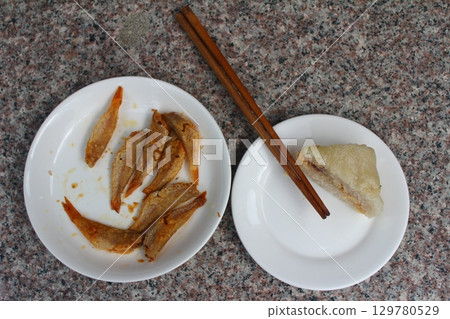 dried fish in basket and plate 129780529